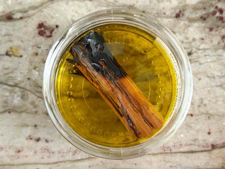 2 charred cinnamon sticks in oil