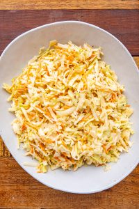Coleslaw accompanied by White BBQ Sauce
